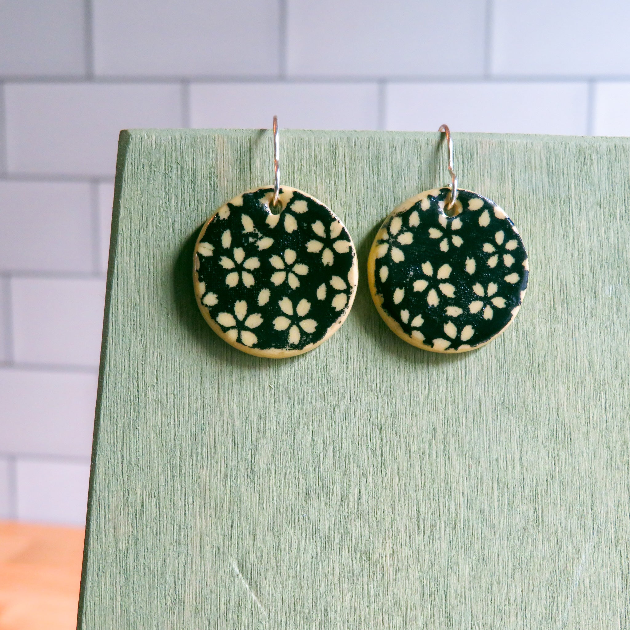 Black Floral Meadow Earrings on Beige Clay - Main Image